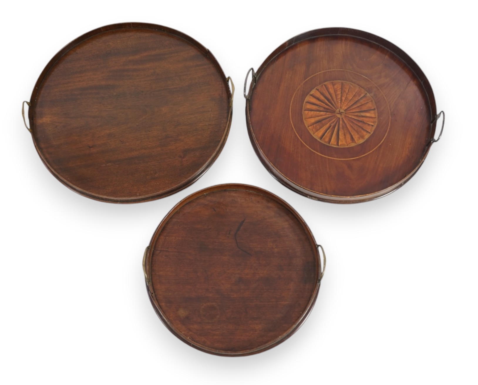 Three George III and later circular mahogany gallery trays